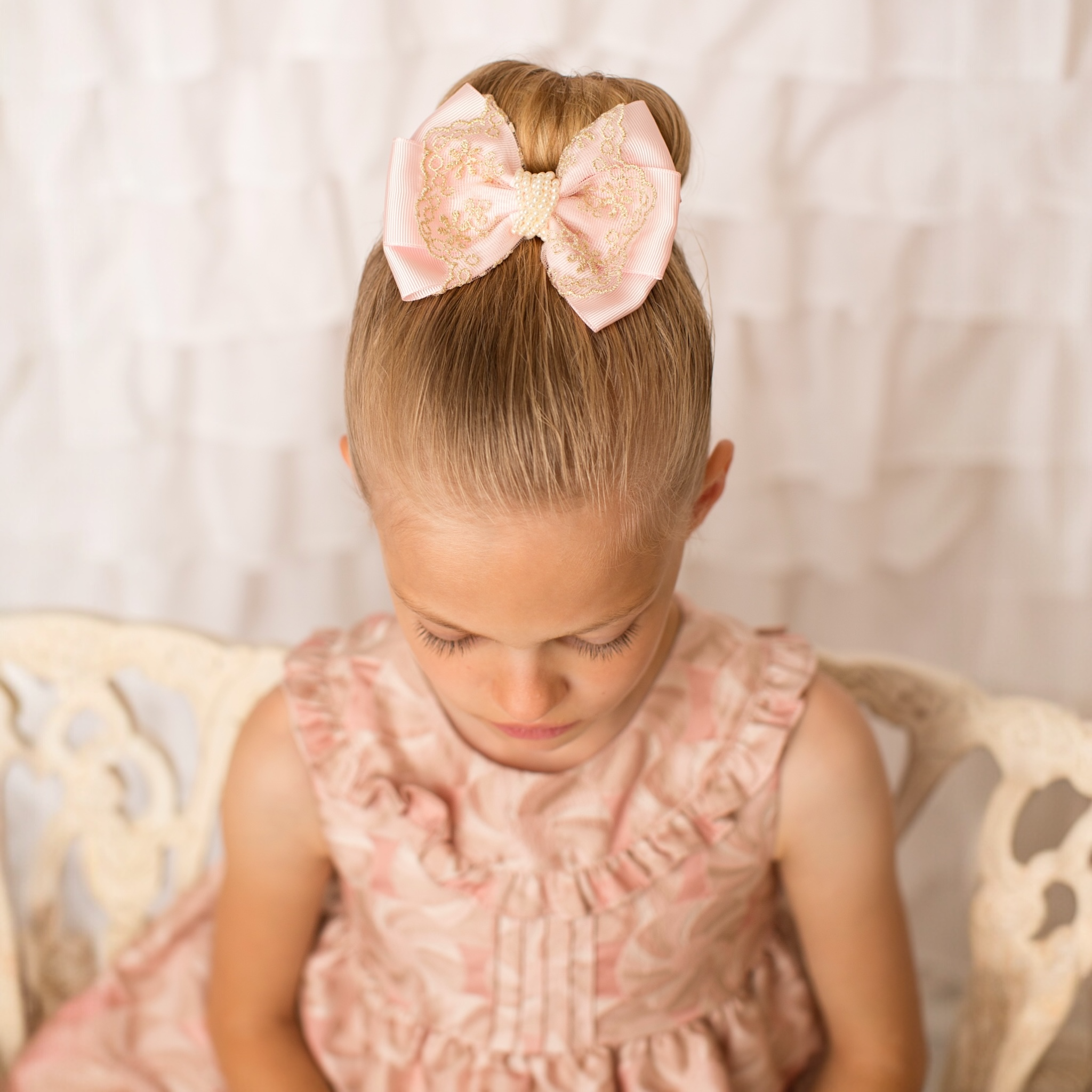 Oversized bow with gold lace and pearls