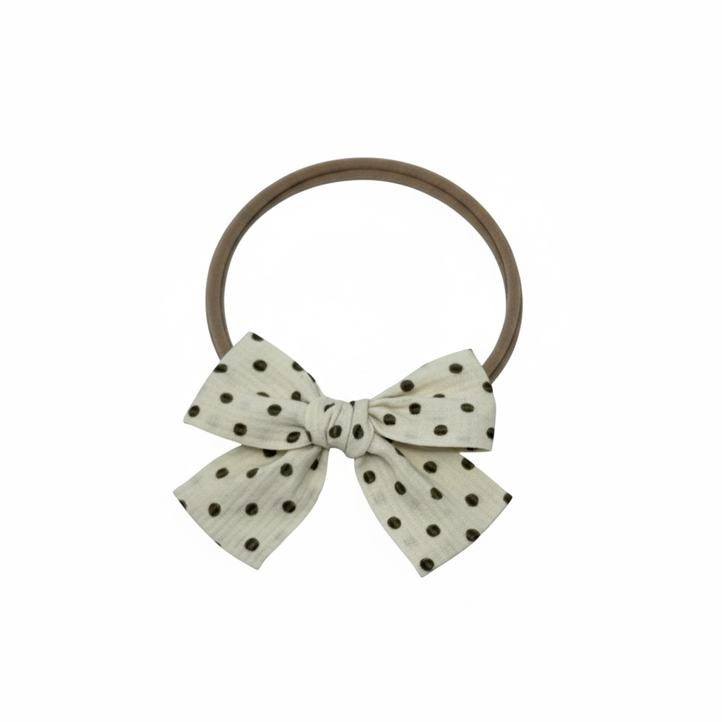 Brown polka dot fabric bow on a headband