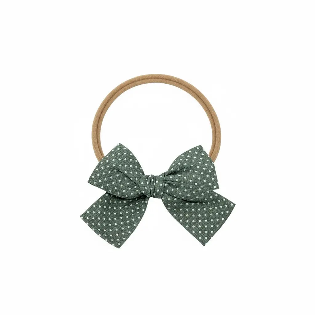 Green polka dot fabric bow on a headband Cute Cute