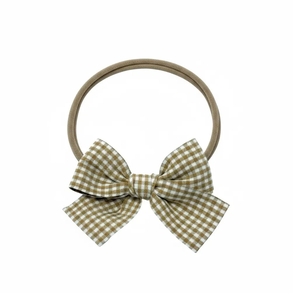Mustard checked fabric bow on a headband. Cute Cute