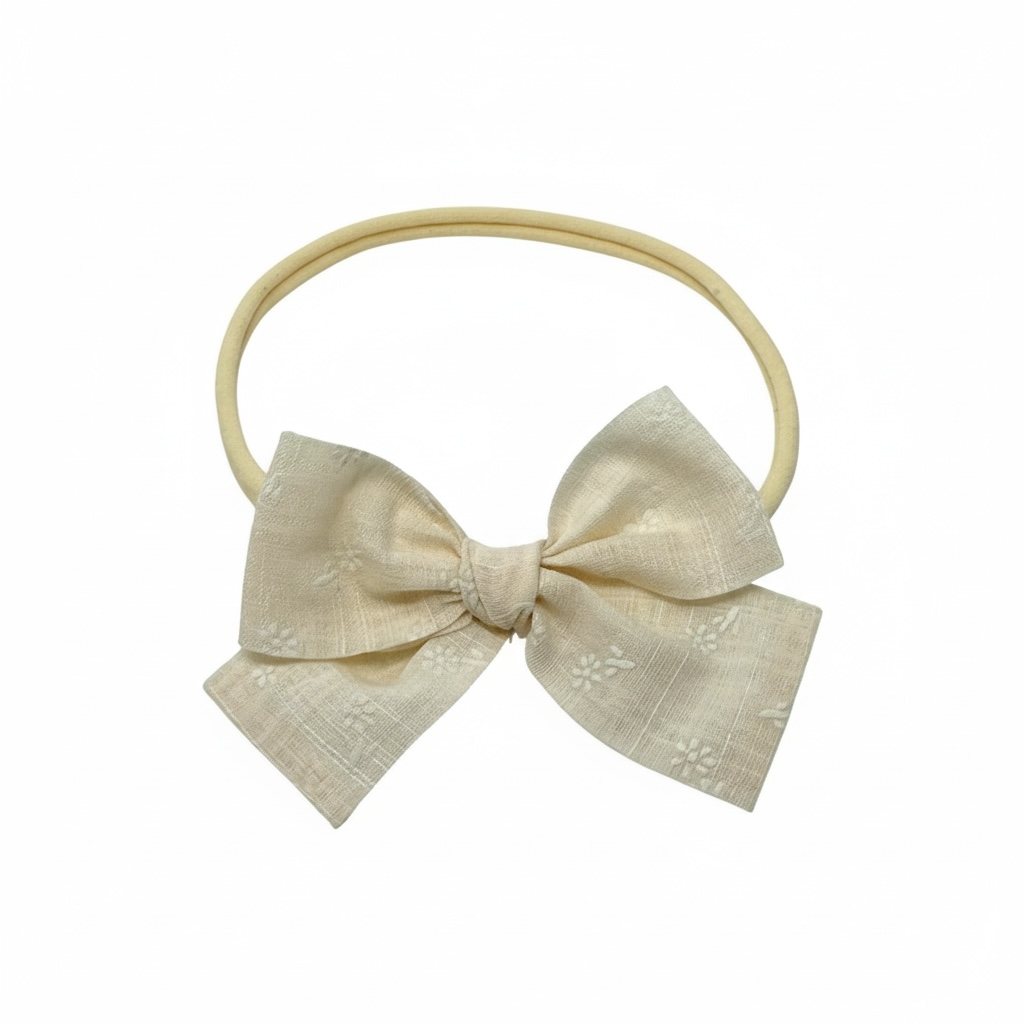 Ivory floral fabric bow on a headband