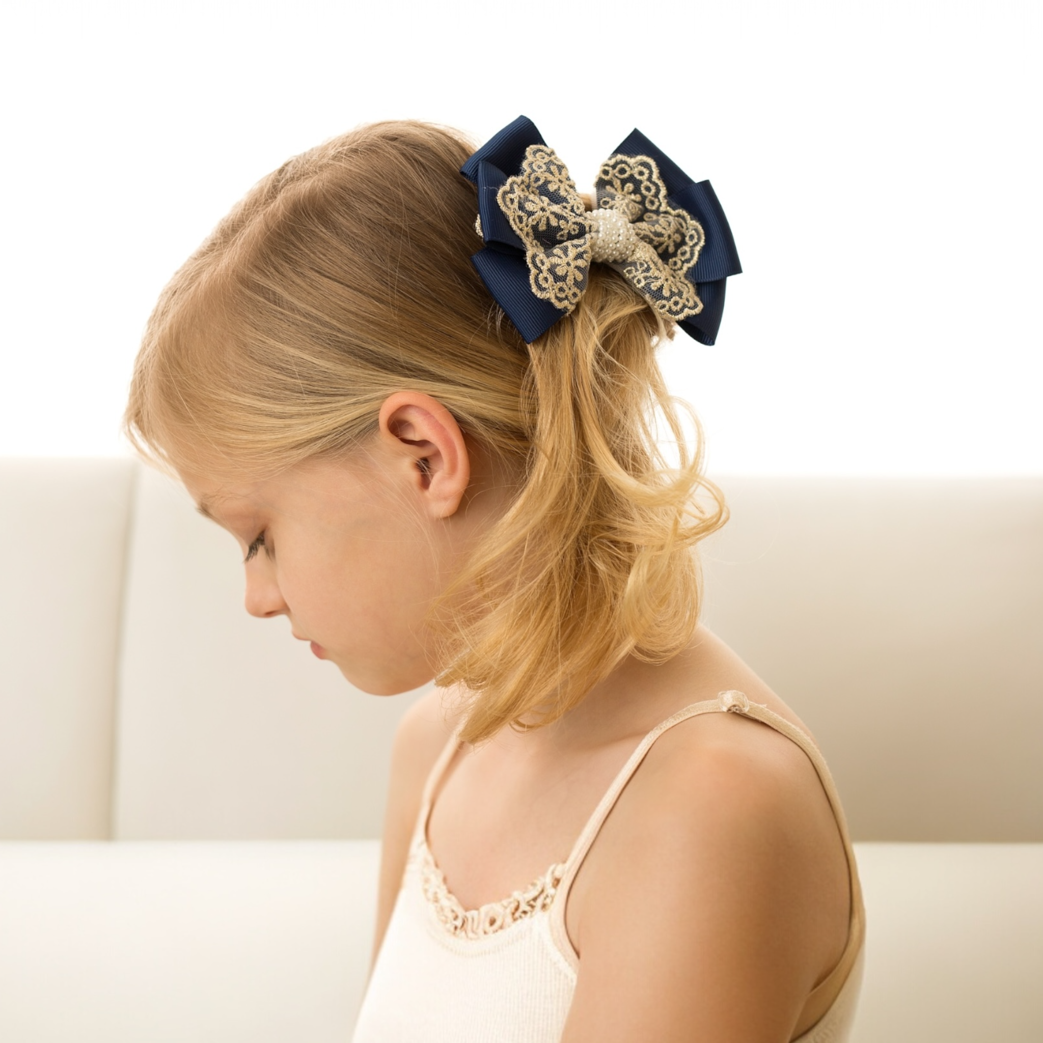 Oversized bow with gold lace and pearls