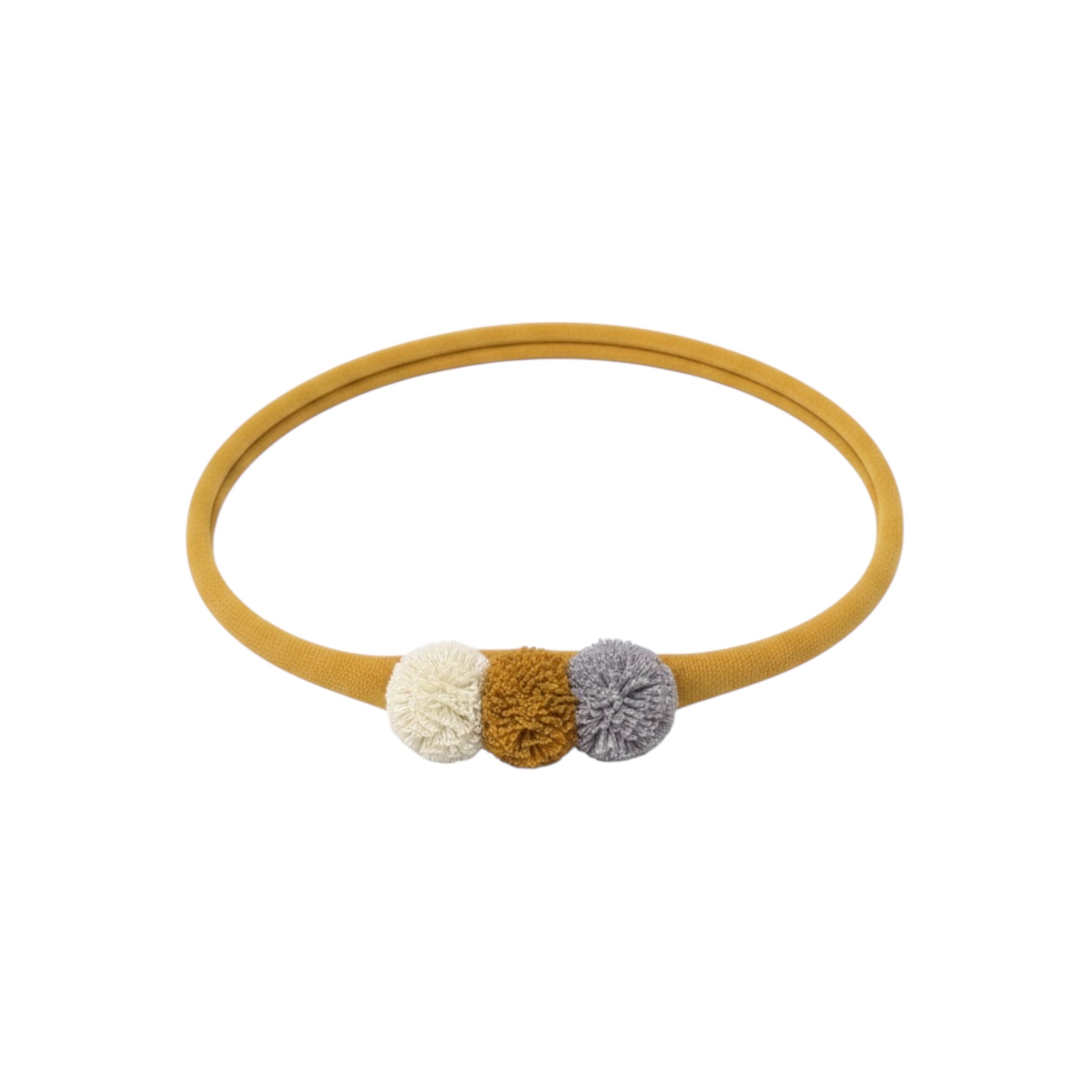 Pom poms in mustard on a headband