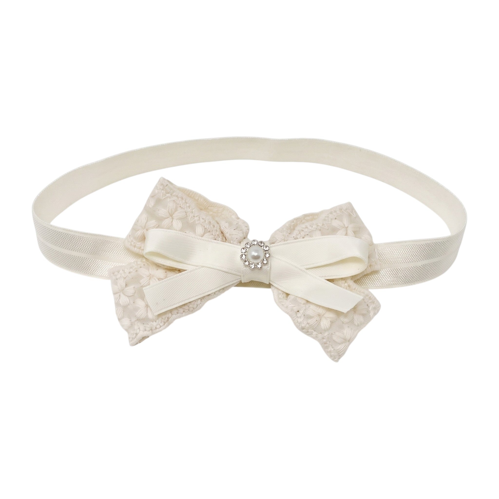 Ivory lace bow with pearl rhinestone on a soft elastic headband.