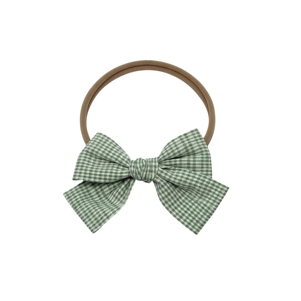Green checked fabric bow on a headband