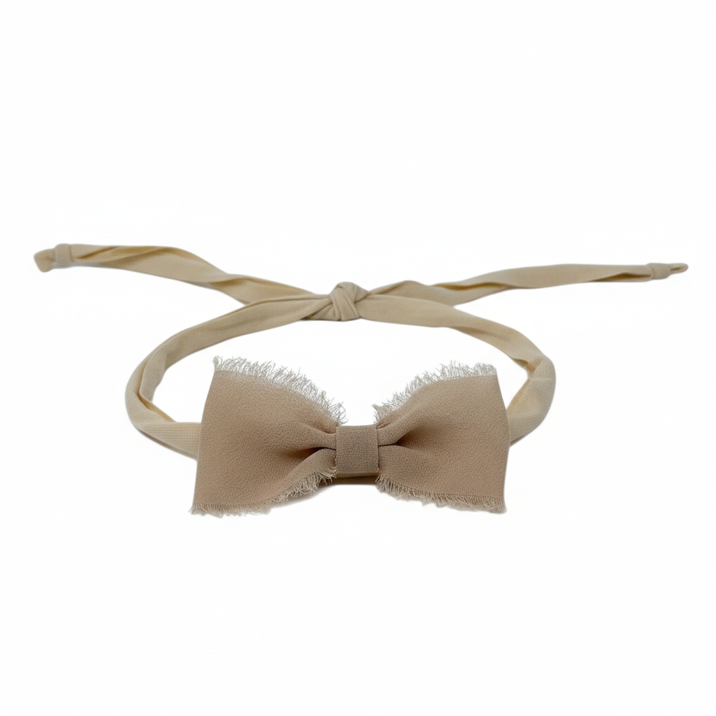 Frayed chiffon bow on an ivory tie back