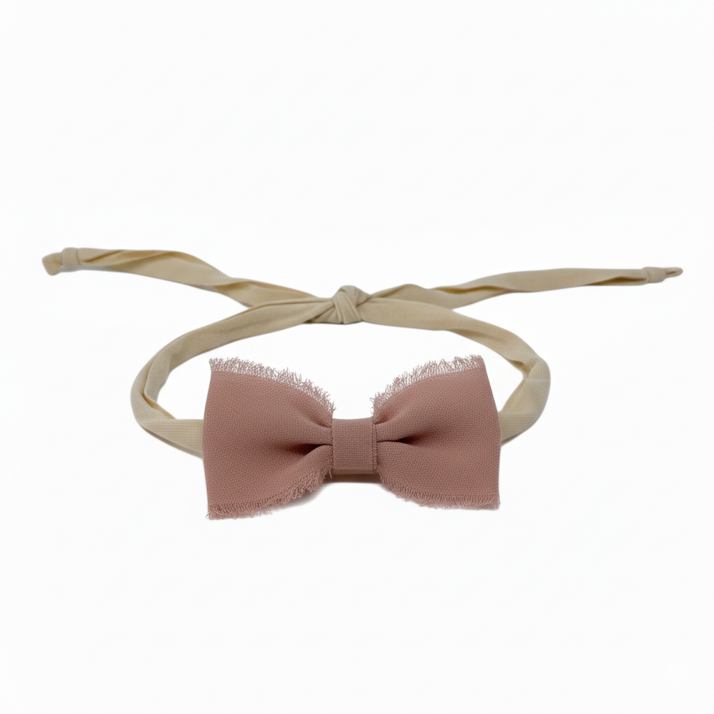 Frayed chiffon bow on an ivory tie back