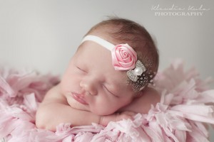 Pink satin rose with guinea feather and rhinestone bow
